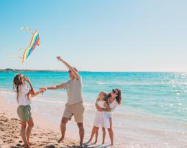 Family with kite on beach